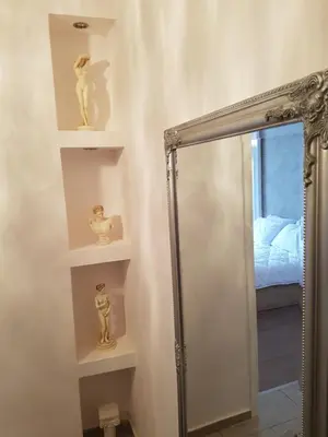 a bathroom with a mirror and a shower with shelves at JOHN BEAUTY 50m2, METRO and ACROPOLIS 5' in Athens