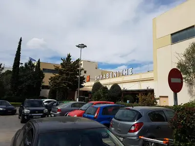 a parking lot with cars parked in front of a building at JOHN BEAUTY 50m2, METRO and ACROPOLIS 5' in Athens
