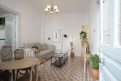a living room with a couch and a table at Live in Athens, THISEIO Historic House in Athens