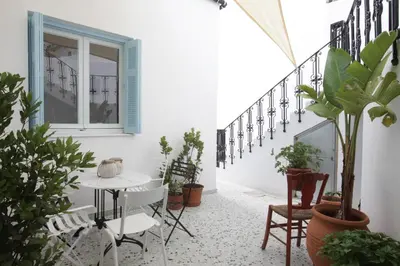 a balcony with a table and some plants at Live in Athens, THISEIO Historic House in Athens