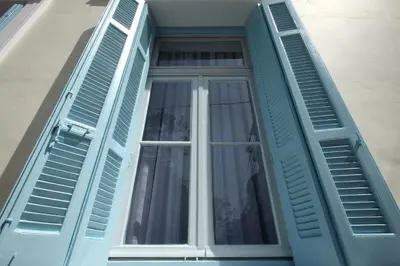 a window with blue shutters on a house at Live in Athens, THISEIO Historic House in Athens