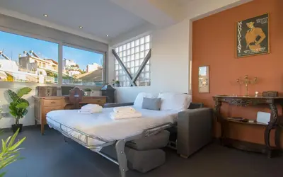 a bedroom with a bed and a large window at 5th flr Boho studio @ Exarheia w/ balcony in Athens