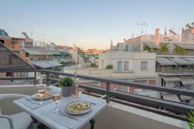 a table with a plate of food on a balcony at 5th flr Boho studio @ Exarheia w/ balcony in Athens
