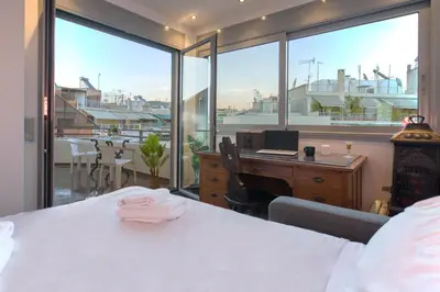 a bedroom with a desk and a computer and windows at 5th flr Boho studio @ Exarheia w/ balcony in Athens