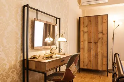 a dressing table with a mirror and a chair at Museum of Modern Art Rooms in apartment, next to metro Suggrou Fix, walk to Acropolis in Athens