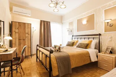 a bedroom with a bed and a table and a desk at Museum of Modern Art Rooms in apartment, next to metro Suggrou Fix, walk to Acropolis in Athens