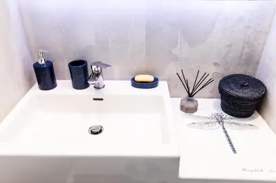 a white sink with various items on top of it at Sweet Suite Flora in Vouliagmeni in Athens