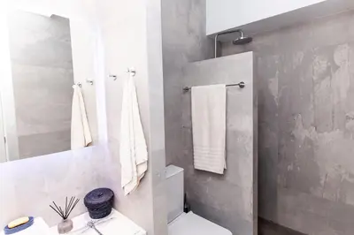 a white bathroom with a toilet and a sink at Sweet Suite Flora in Vouliagmeni in Athens