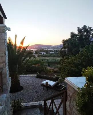 a garden with a bench and a view of a city at Villa Vena in Palaiá Fókaia