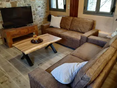 a living room with a couch and a coffee table at Villa Vena in Palaiá Fókaia