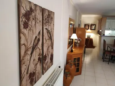 a living room with a large painting on the wall at Villa Vena in Palaiá Fókaia