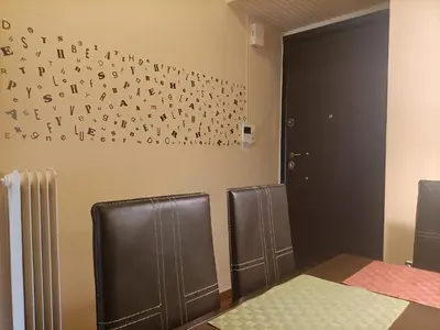 a room with two chairs and a wall with letters on it at Charming Retreat in Athens