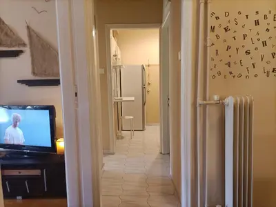 a room with a television and a hallway with a hallway at Charming Retreat in Athens