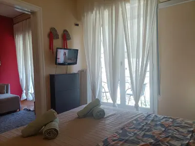 a bedroom with a bed and a large window at Charming Retreat in Athens