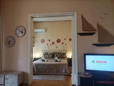 a bedroom with a bed and a tv and a mirror at Charming Retreat in Athens