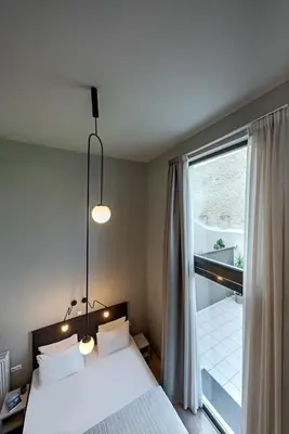 a bedroom with a bed and a large window at BED in Athens in Athens