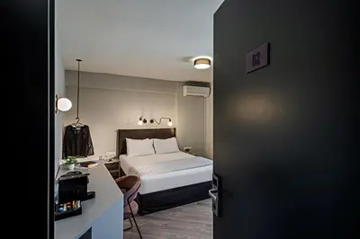 a bedroom with a bed and a desk and a bed sidx sidx sidx at BED in Athens in Athens