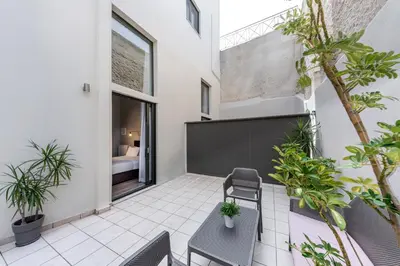 a patio with a table and chairs and plants at BED in Athens in Athens
