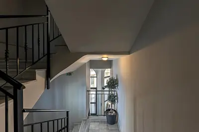 a hallway with stairs and a potted plant at BED in Athens in Athens