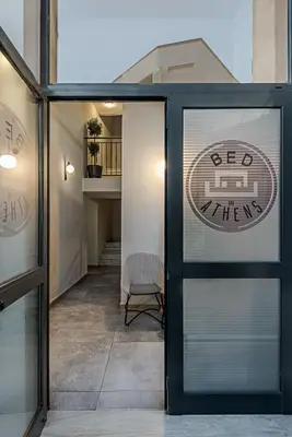 a glass door with a sign on it in a building at BED in Athens in Athens