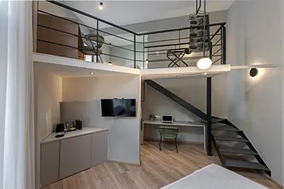 a room with a loft bed and a desk and a deskablishangering at BED in Athens in Athens