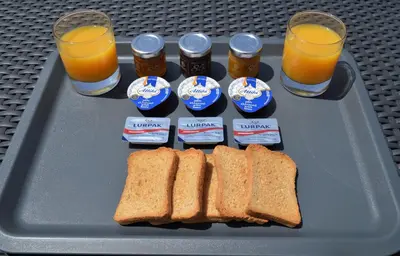 a tray with peanut butter and jelly and sandwiches and glasses of orange juice at Athens Riviera Loft in Athens