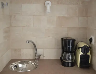 a kitchen counter with a coffee maker next to a sink at Athens Riviera Loft in Athens