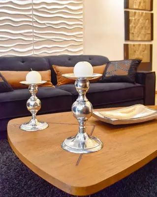 a coffee table with two silver candlesticks on it at Lycabettus Exclusive Apartments in Athens