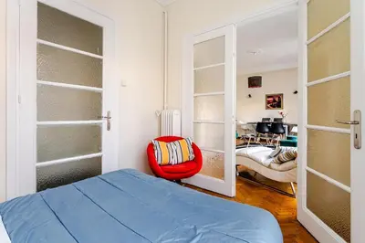 a bedroom with a blue bed and a red chair at 3BDR IDEAL CENTRAL ATHENIAN APT in Athens