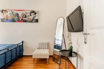 a bedroom with a bed and a table and a tv at 3BDR IDEAL CENTRAL ATHENIAN APT in Athens