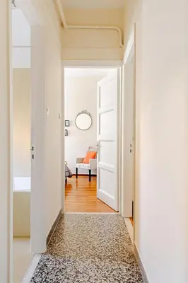 a hallway with a white door and a rug at 3BDR IDEAL CENTRAL ATHENIAN APT in Athens