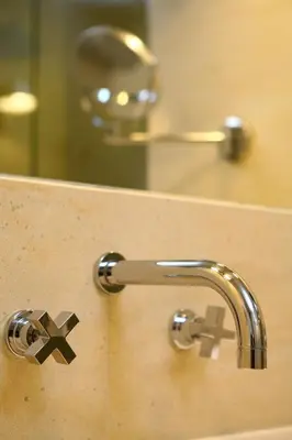 a bathroom sink with a faucet and a mirror at O&B Athens Boutique Hotel in Athens