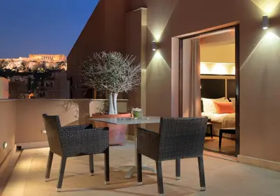 a dining room with a table and chairs and a bedroom at O&B Athens Boutique Hotel in Athens