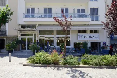 a large white building with a patio in front of it at Phidias Hotel by Oniro in Athens