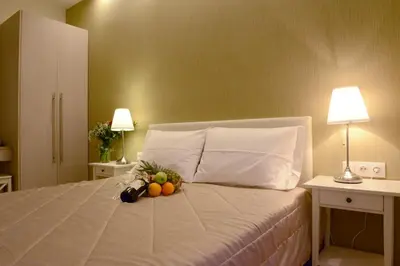 a bed with a bunch of fruit on it at Phidias Hotel by Oniro in Athens