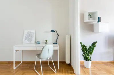 a white desk with a chair and a plant at Urban Chic 1BD Apartment in Hilton district by UPSTREET in Athens