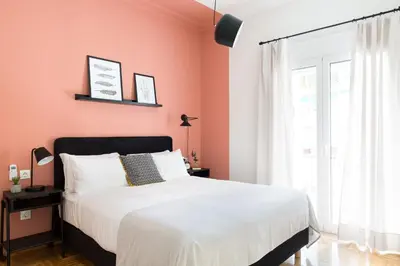 a bedroom with pink walls and a large bed at Urban Chic 1BD Apartment in Hilton district by UPSTREET in Athens