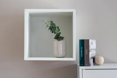 a white shelf with a vase with a plant in it at Urban Chic 1BD Apartment in Hilton district by UPSTREET in Athens
