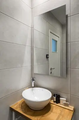 a bathroom with a white bowl sink and a mirror at Urban Chic 1BD Apartment in Hilton district by UPSTREET in Athens