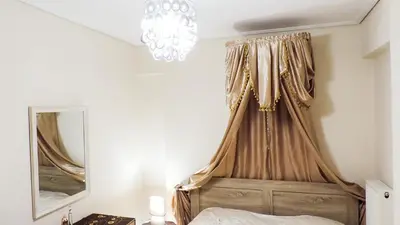a bedroom with a canopy bed and a mirror at Penthouse Deluxe apartment at piraeus in Piraeus