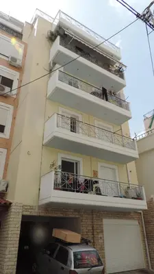 a building with a car parked in front of it at Penthouse Deluxe apartment at piraeus in Piraeus