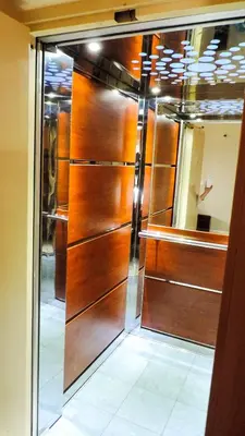 a closet with wooden doors in a room at Penthouse Deluxe apartment at piraeus in Piraeus