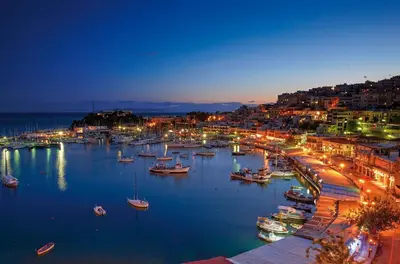 a harbor with boats in the water at night at Penthouse Deluxe apartment at piraeus in Piraeus