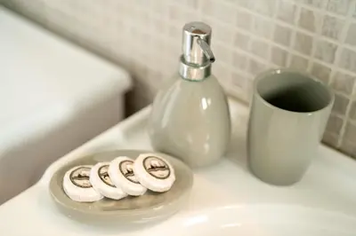 a plate of donuts on a sink with a bottle of soap at V&V Acropolis view apartment in Athens
