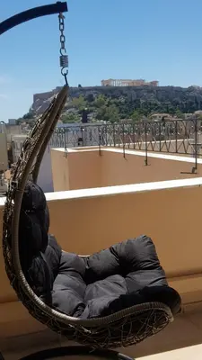 a hammock on top of a balcony with a view at V&V Acropolis view apartment in Athens