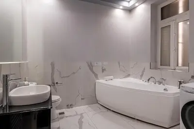a bathroom with a tub and a toilet and a sink at The Hadrian Wall - A Historic Acropolis Villa in Athens