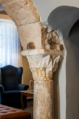 a large stone vase sitting in a living room at The Hadrian Wall - A Historic Acropolis Villa in Athens
