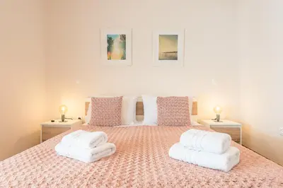 a bedroom with a large bed with white pillows at Stylish Athenian Flat in Athens