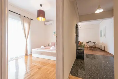 a bedroom with a bed and a table in a room at Stylish Athenian Flat in Athens