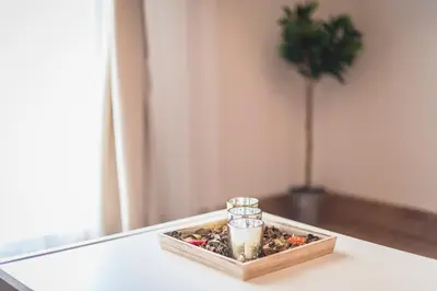 a tray with a candle and a glass jar on a table at Stylish Athenian Flat in Athens